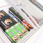 Image of the inside of a 176L small white display chest freezer with frozen goods.