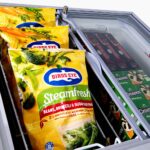 Image of the inside of a 192L small white display chest freezer with frozen goods.