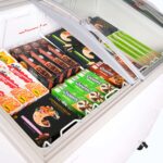 Image of the inside of a 264L small white display chest freezer with frozen goods.