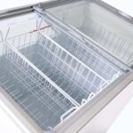 Image of the inside of 296L small white display chest freezer with frozen goods, lid open.
