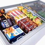 Image of the inside of a 491L medium white display chest freezer with colourful frozen goods inside.