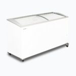 Image of a 555L large white display chest freezer with a curved glass top, left angled view.