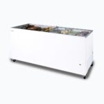 Image of a 670L large white display chest freezer with a flat glass top, right angled view with frozen goods inside.