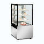 Image of a 660mm wide stainless steel cold food display, left angled view with desserts inside.