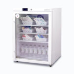 Image of a small 145L display medical and vaccine fridge, right angled view with medicine inside.