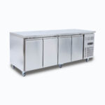 Image of 553L stainless steel under bench storage freezer with four hinged doors, left angled view.