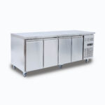 Image of a 553L stainless steel under bench storage fridge with four hinged doors, left angled view.