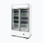 Image of a 960L white cassette upright display fridge with lightbox and two doors, right angled view with drinks inside.
